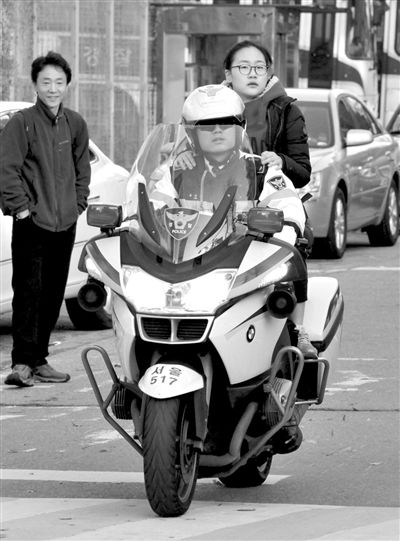 7日，首爾，警察將一名考生送抵考場。新華社發(fā)