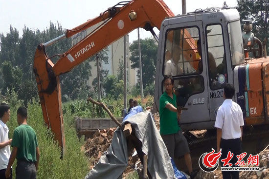 陳寶成手持自制刀斧守在挖掘機旁阻止便衣民警靠前。（視頻截圖）