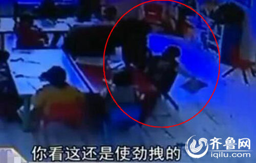 孩子上課時(shí)被老師拖拽。（紅圈中拿書者系孩子）