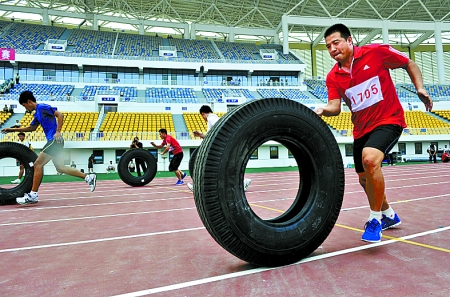 8月15日，運(yùn)動(dòng)員們正在進(jìn)行推輪胎賽跑。